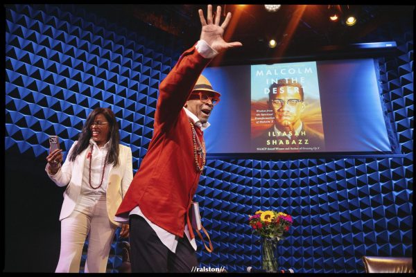Spike Lee waves to audience on stage with Ilyasah Shabazz.

Photo Credit: @ralstonrsmith